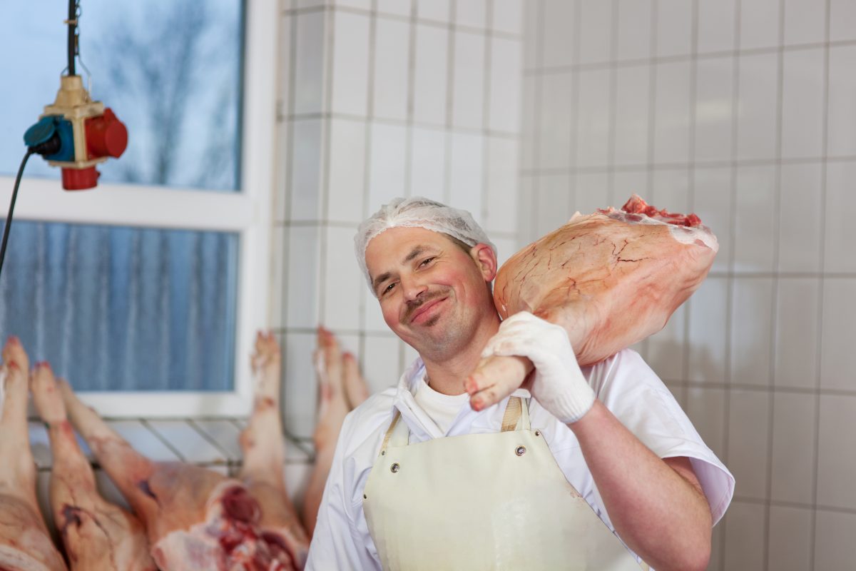 butcher carrying a leg of ham